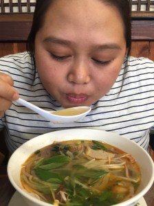 Enjoying her spicy beef noodle soup